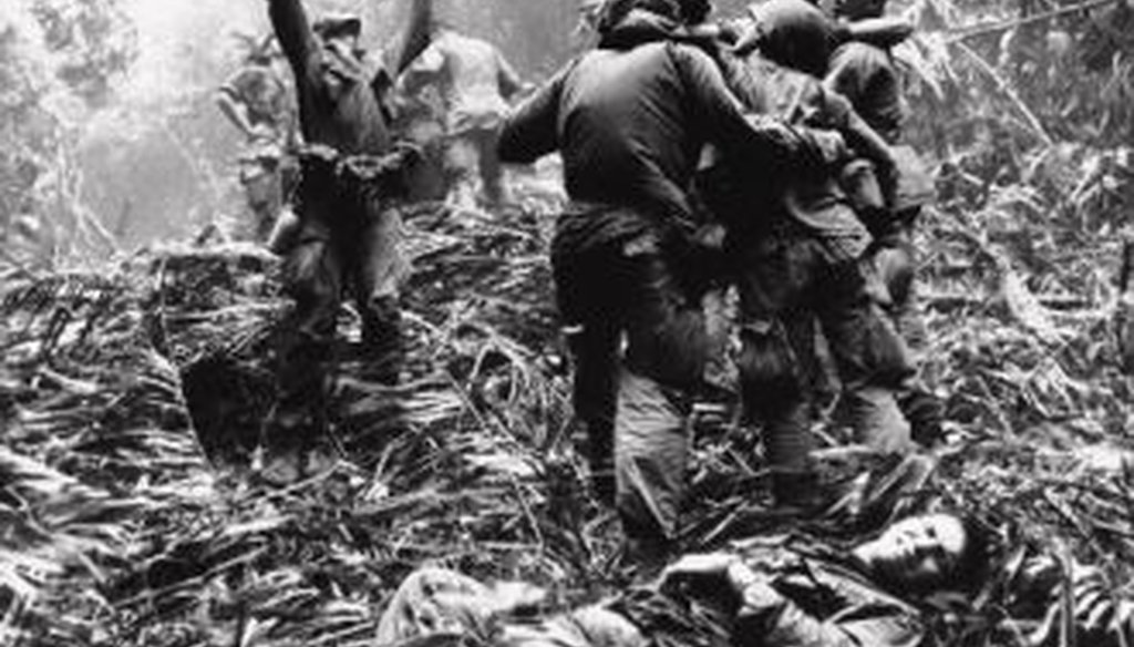 As fellow soldiers aid wounded buddies, a paratropper of A Company, 101st Airborne, guides a medical evacuation helicopter through the jungle foliage to pick up casualties during a five-day patrol of Hue, South Vietnam, in April, 1968. 