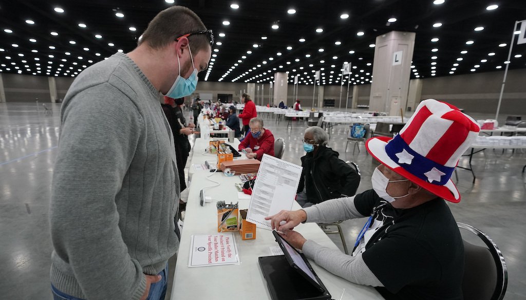 Spencer Crabtree, left, receives instructions from David Lee Mitchell before Crabtree marks his ballot at the Kentucky Exposition Center, on Election Day, Nov. 3, 2020, in Louisville. (AP)