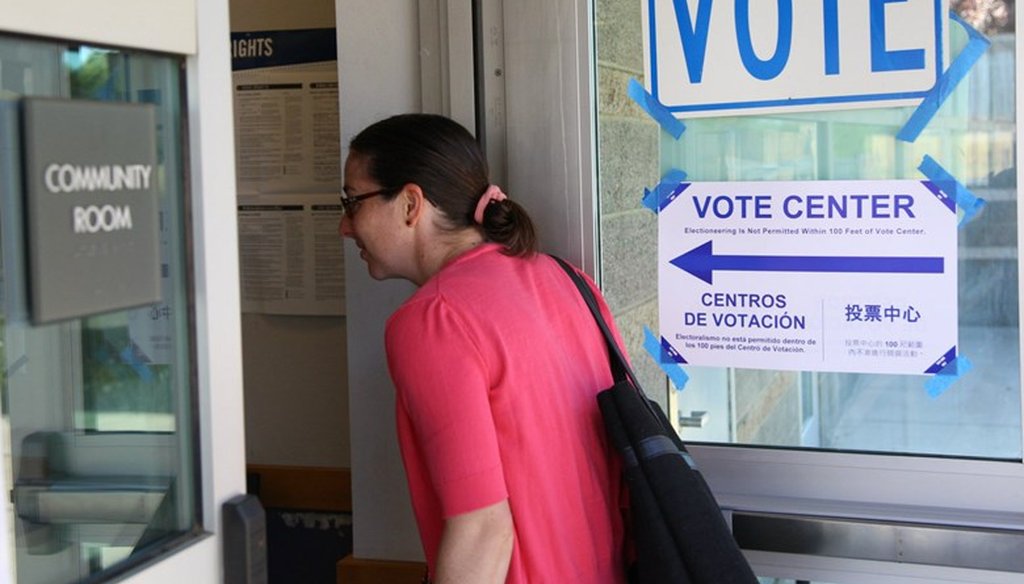 A woman in Sacramento, Calif. drops off her ballot at a vote center. Andrew Nixon / CapRadio