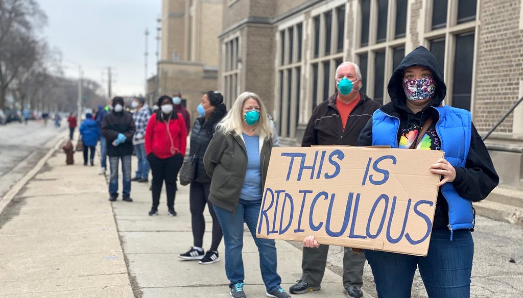 Milwaukee resident Jennifer Taff (holding sign) had been standing in line at Washington High School for almost two hours on Election Day, April 7, 2020. Patricia McKnight / Milwaukee Journal Sentinel