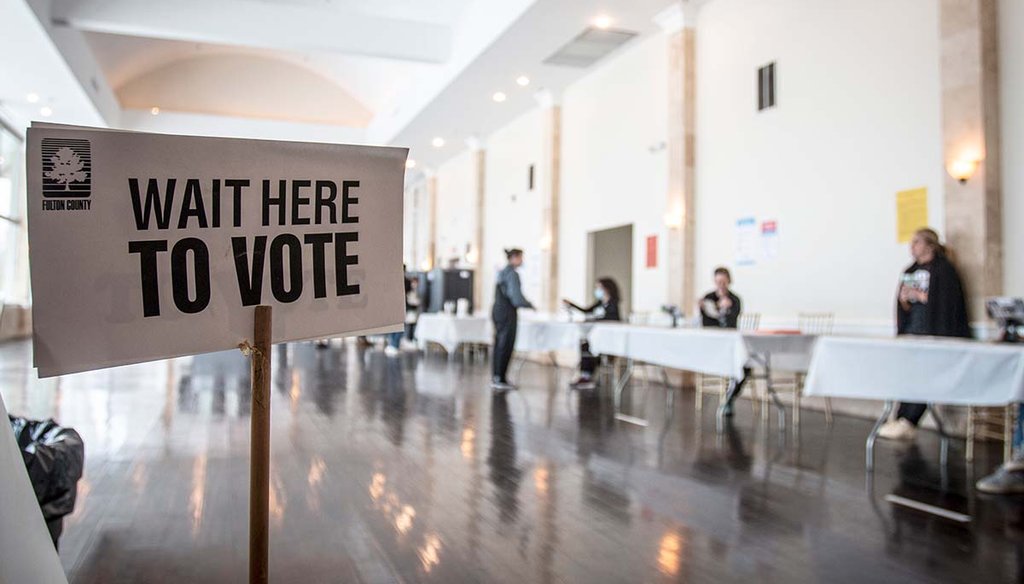 Polling location workers await a rush of lunchtime voters in Georgia’s U.S. Senate runoff election on Tuesday, Dec. 6, 2022, in Atlanta. (AP)