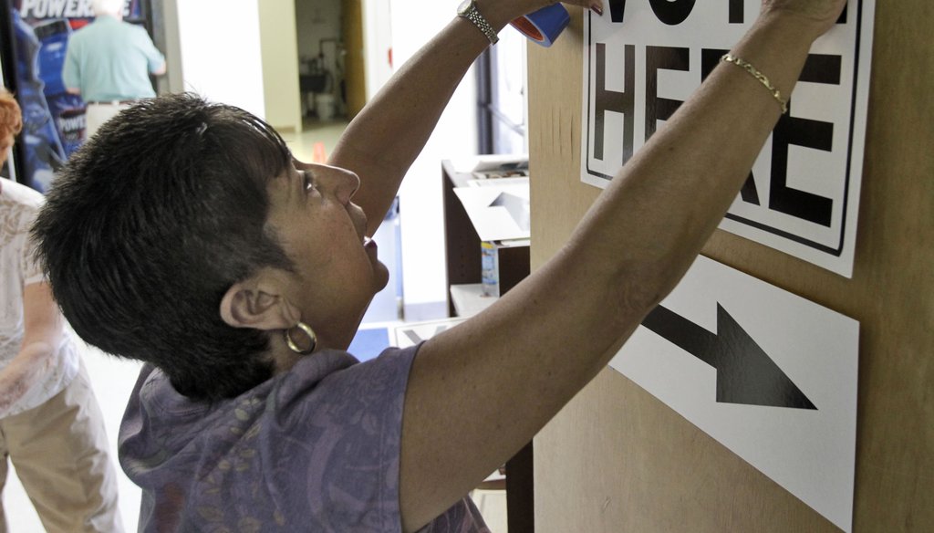 A worker sets up a polling station.