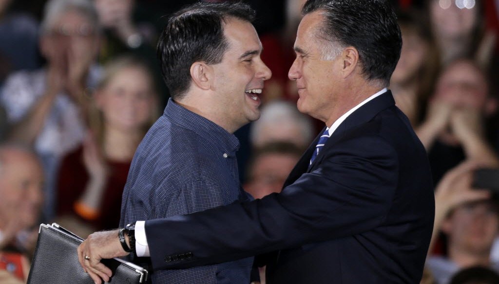 Republican presidential candidate Mitt Romney embraces Gov. Scott Walker at a 2012 campaign event in West Allis. (AP Photo)