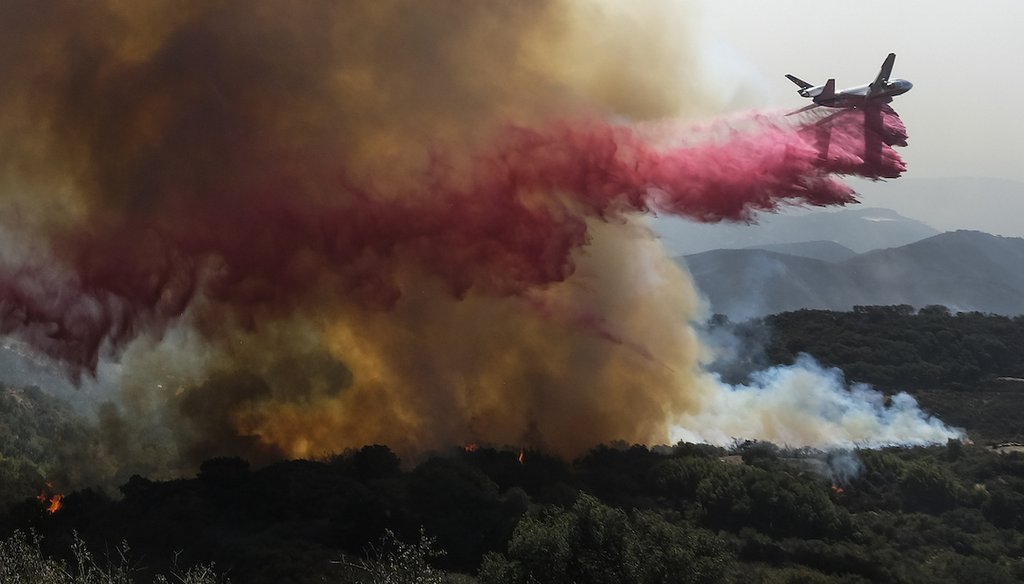 An air tanker drops retardant on a wildfire in Goleta, Calif., part of the 22 square mile Alisal Fire. (AP Photo)