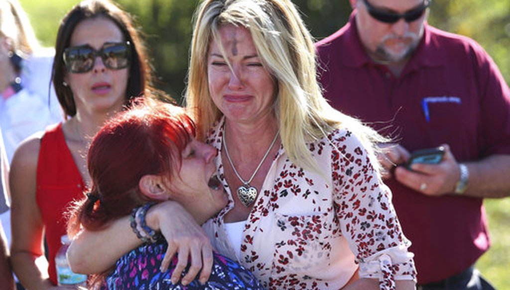 Parents wait for news after a reports of a shooting at Marjory Stoneman Douglas High School in Parkland, Fla., on Wednesday, Feb. 14, 2018. (AP)