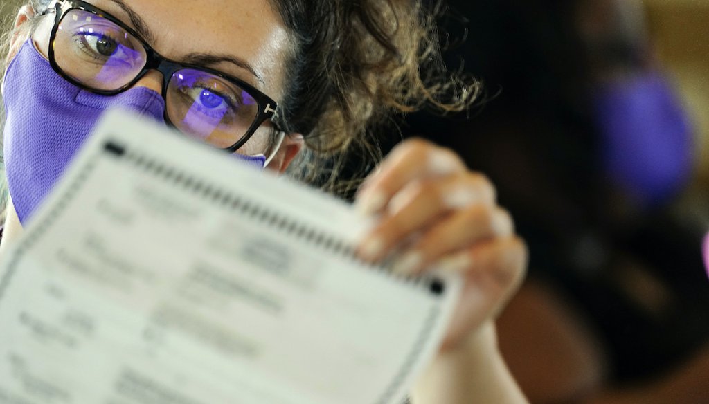 A Georgia election worker examines ballots at State Farm Arena Nov. 5, 2020, in Atlanta. (AP)