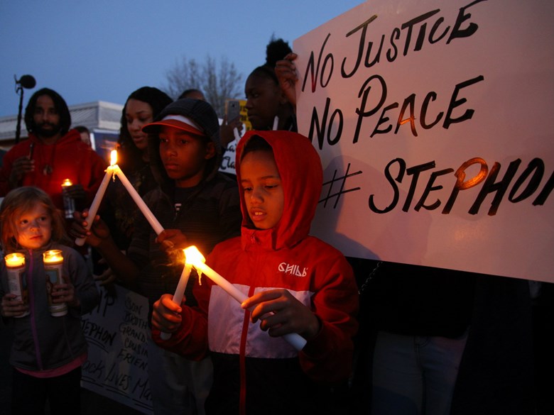 Children light candles at a vigil for Stephon Clark in South Sacramento. Andrew Nixon / Capital Public Radio