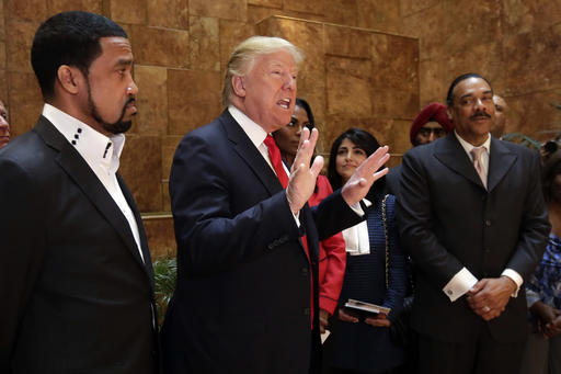 Pastor Darrell Scott, at left, listens as then-candidate Donald Trump speaks at Trump Tower on April 18, 2016.