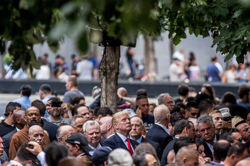 Then Republican presidential candidate Donald Trump, center, attends a ceremony at the Sept. 11 memorial, in New York, Sunday, Sept. 11, 2016 (AP).