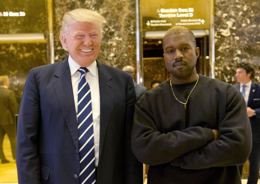 Donald Trump, then the president-elect, poses with Kanye West in the lobby of Trump Tower in New York on Dec. 13, 2016. (AP/Seth Wenig)