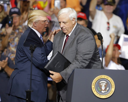 President Donald Trump talks with West Virginia Gov. Jim Justice during a rally on Aug. 3, 2017, in Huntington, W.Va. (AP)