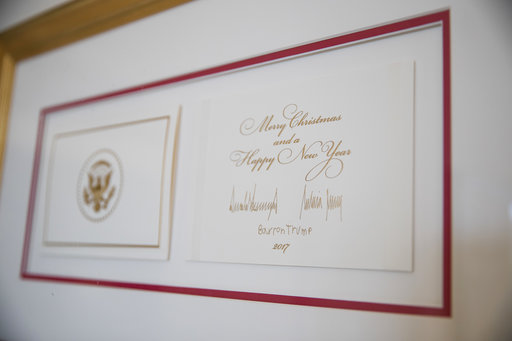 The official White House Christmas card signed by President Donald Trump, first lady Melania Trump, and their son Barron Trump at the White House, Nov. 27, 2017. (AP Photo/Carolyn Kaster)