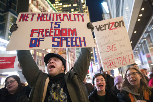 Demonstrators rally in support of net neutrality outside a Verizon store, Thursday, Dec. 7, 2017, in New York. (AP Photo/Mary Altaffer)