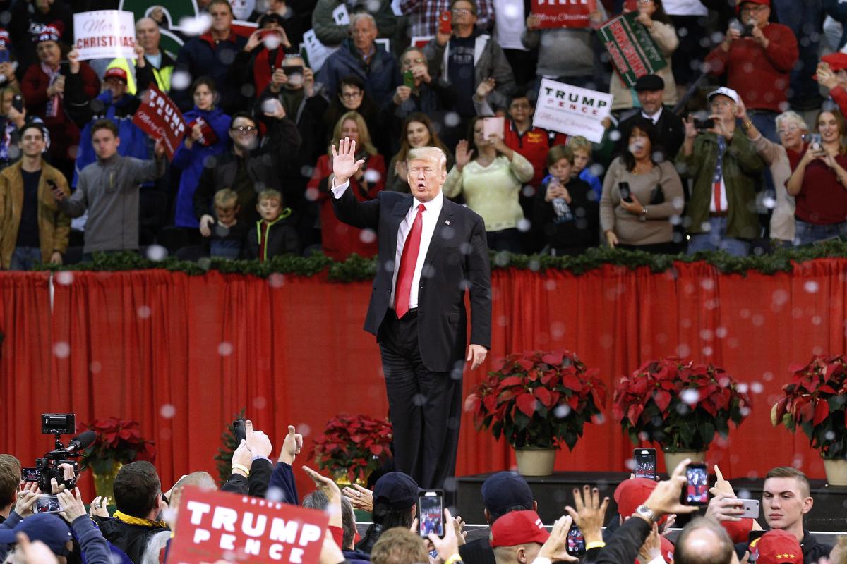 President Donald Trump waves to supporters during a rally in Pensacola, Fla., Dec. 8, 2017, as fake snow falls after his speech. (AP)