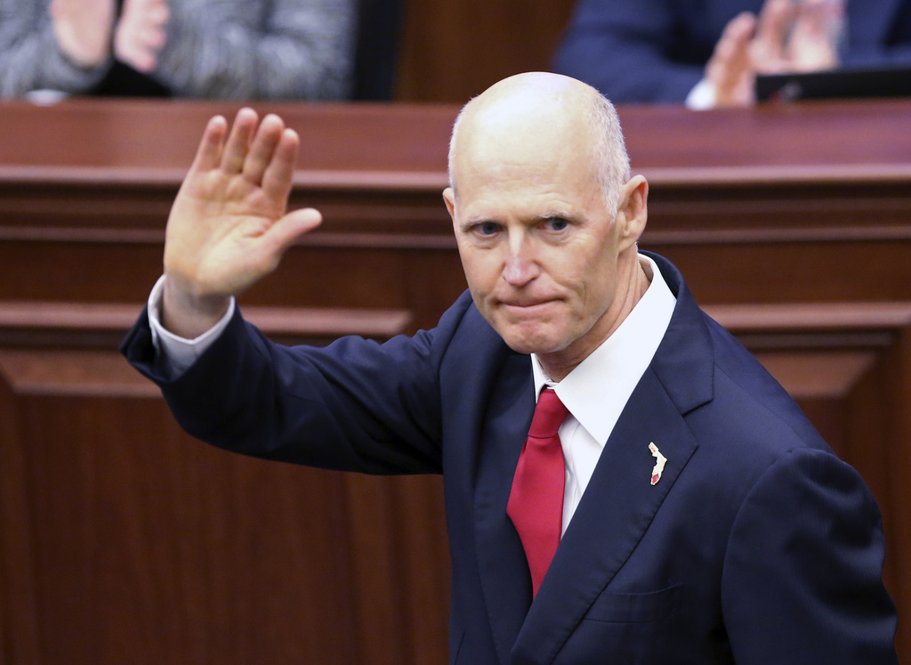Gov. Rick Scott waves as he is introduced to the Senate on the first day of legislative session, Tuesday, Jan. 9, 2018, in Tallahassee, Fla. (AP Photo/Steve Cannon)