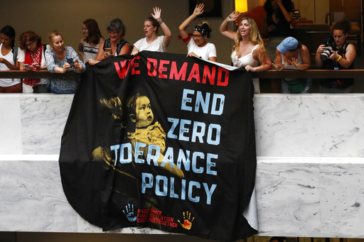 Women hold a sign that says "we demand end zero tolerance policy," in a hallway during a protest of the separation of immigrant families June 28, 2018, on Capitol Hill in Washington. (AP Photo/Jacquelyn Martin)