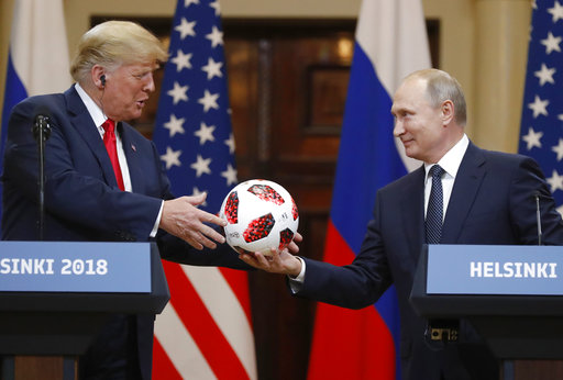 Russian President Vladimir Putin gives a soccer ball to U.S. President Donald Trump during a press conference after their meeting in Helsinki, Finland, on July 16, 2018. (AP/Alexander Zemlianichenko)