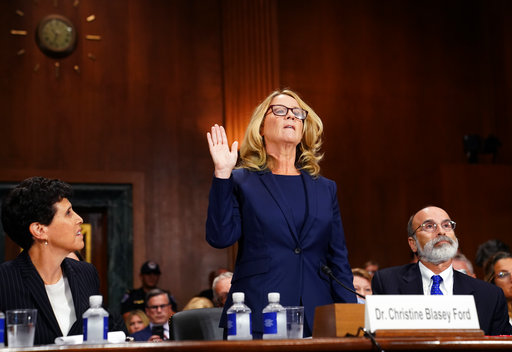 Christine Blasey Ford is sworn in to testify before the Senate Judiciary Committee on Capitol Hill in Washington, Thursday, Sept. 27, 2018. Her attorney's Debra Katz and Michael Bromwich watch. (AP Photo/Andrew Harnik, Pool)
