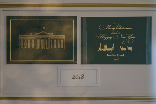 The First Family's holiday card is seen behind glass in Booksellers during the 2018 Christmas preview at the White House in Washington, Monday, Nov. 26, 2018. (AP Photo/Carolyn Kaster)