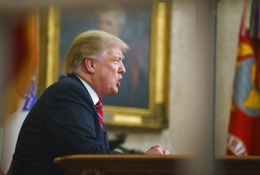 As seen from a window outside the Oval Office, President Donald Trump gives a prime-time address about border security Tuesday, Jan. 8, 2018, at the White House in Washington. (AP Photo/Carolyn Kaster)