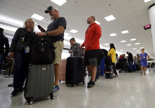 Passengers wait in line at Miami International Airport on Jan. 11, 2019. (AP)