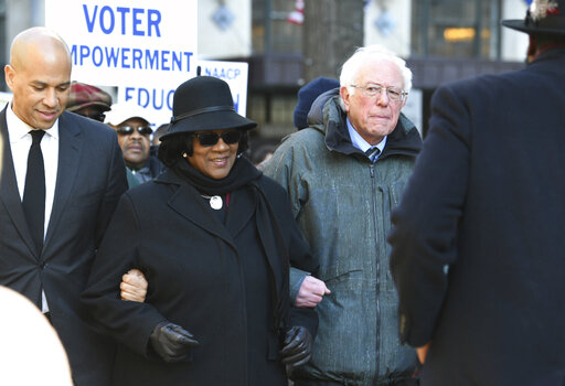 Sen. Cory Booker, D-N.J., left, and Sen. Bernie Sanders, I-Vt., right, march with NAACP President Brenda Murphy Jan. 21, 2019, march in Columbia, S.C. (AP Photo)