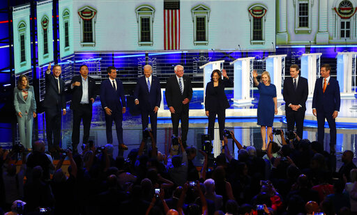 Democratic presidential candidates wave as they enter the stage for the second night of the Democratic primary debate, Thursday, June 27, 2019, in Miami (AP).
