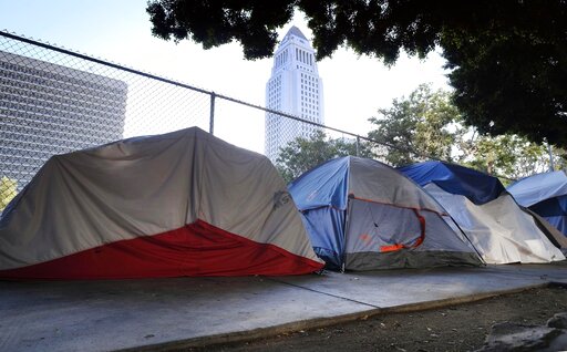 Los Angeles City Hall is seen behind a homeless tent encampment along a street in downtown Los Angeles on July 1, 2019. (AP/Vogel)