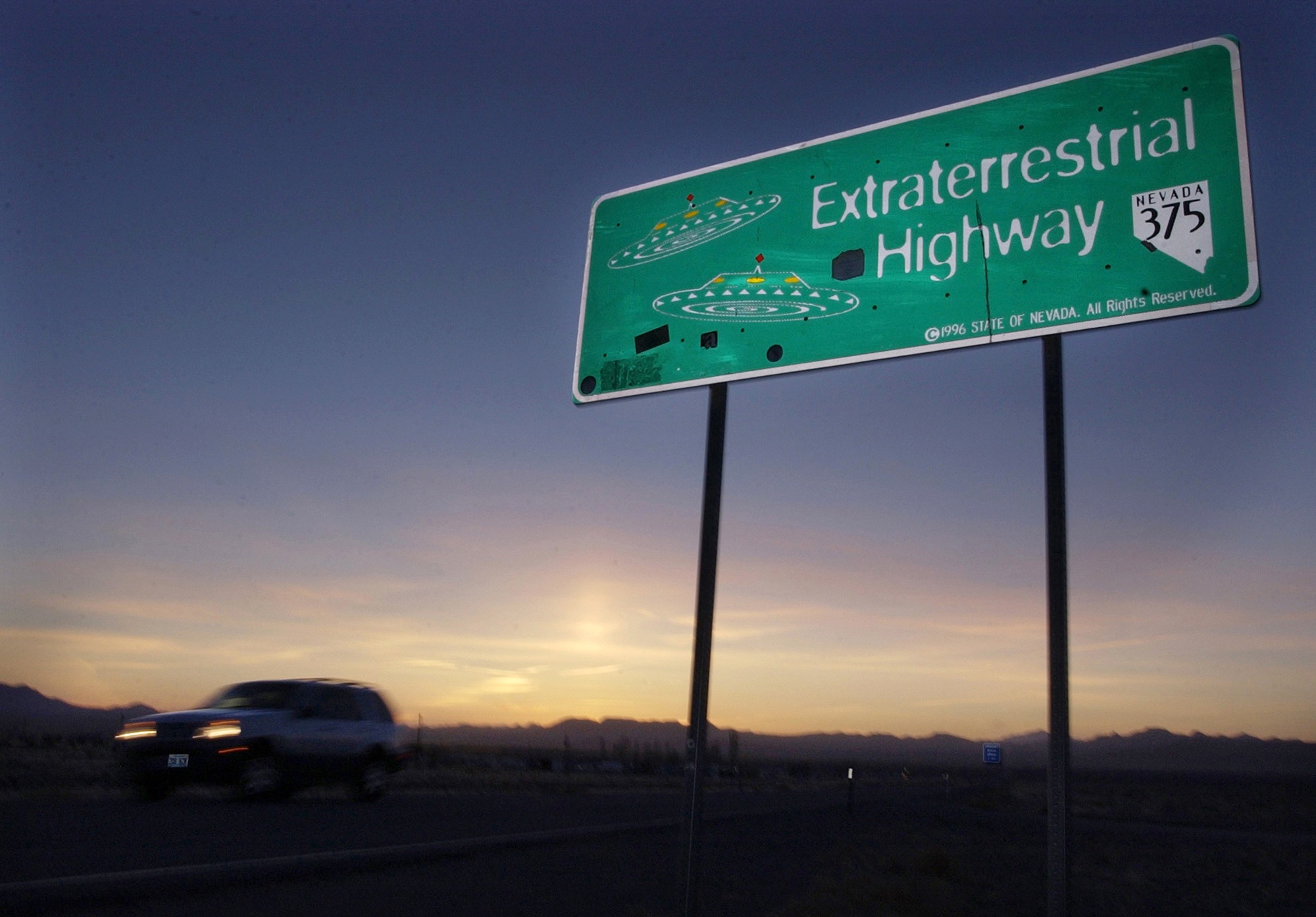 In this April 10, 2002, file photo, a vehicle moves along the Extraterrestrial Highway near Rachel, Nev., the closest town to Area 51. (AP Photo/Laura Rauch, File)