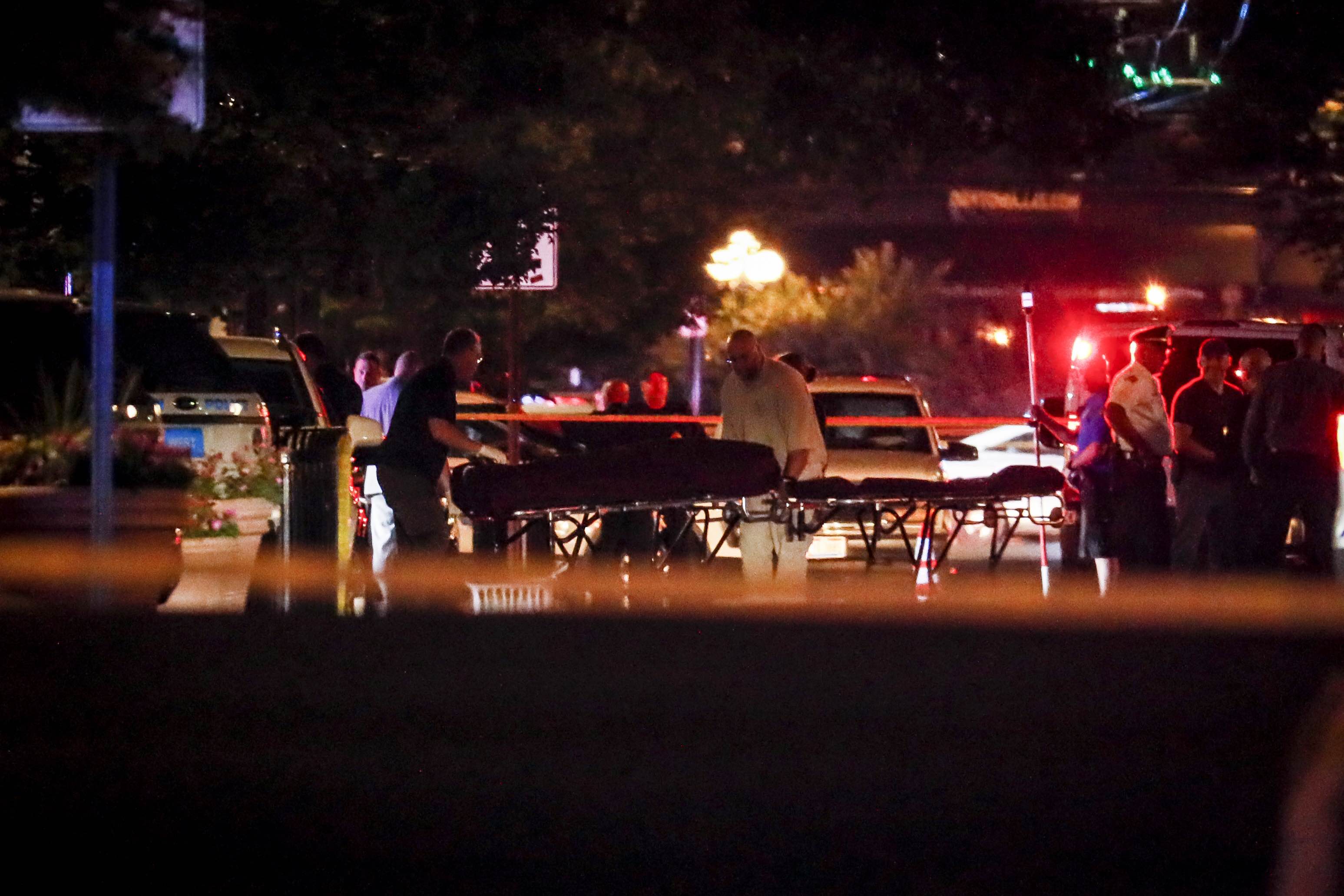 Bodies are removed from at the scene of a mass shooting, Sunday, Aug. 4, 2019, in Dayton, Ohio. (AP Photo/John Minchillo)