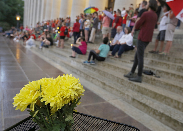 People attend a candlelight vigil at the Ohio Statehouse in Columbus after mass shootings in Ohio and Texas. (AP)