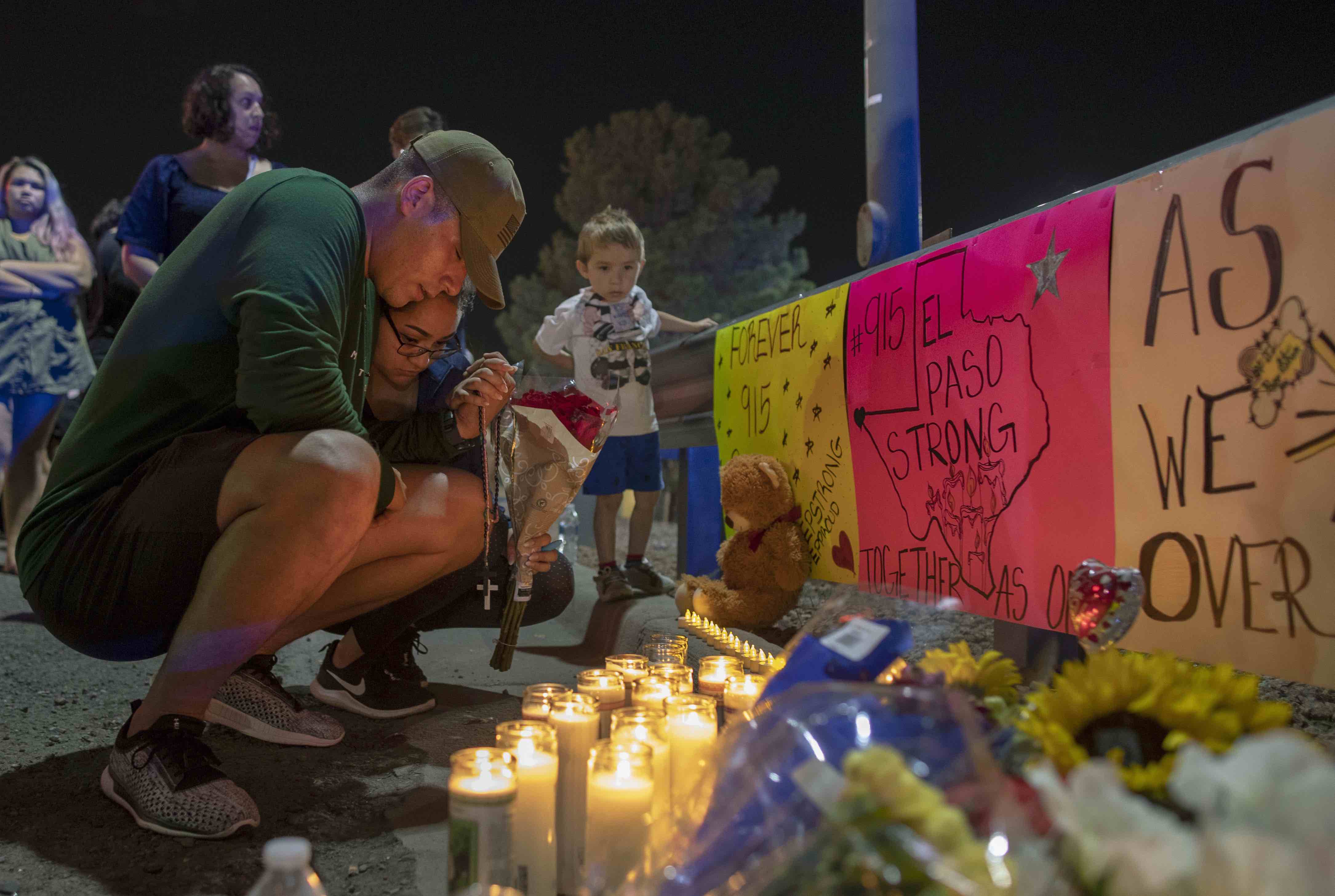 People gather in Juarez, Mexico, Saturday, Aug. 3, 2019, in a vigil for the three Mexican nationals who were killed in an El Paso shopping-complex shooting. (AP Photo/Andres Leighton)