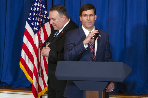 Secretary of State Mike Pompeo, left, hands off the microphone to Secretary of Defense Mark Esper to deliver a statement on Dec. 29, 2019, in Palm Beach, Fla. (AP/Vucci)