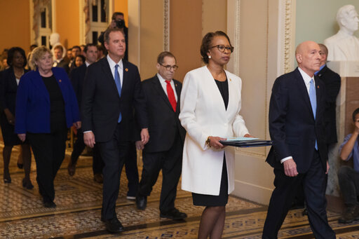 House Sergeant at Arms Paul Irving and Clerk of the House Cheryl Johnson carry the articles of impeachment against President Donald Trump to Secretary of the Senate Julie Adams on Jan. 15, 2020. (AP)