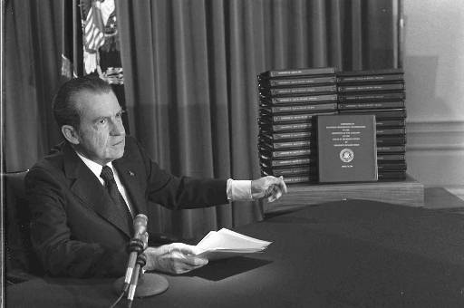 President Richard M. Nixon is shown pointing to the transcripts of the White House tapes on April 29, 1974. (AP)