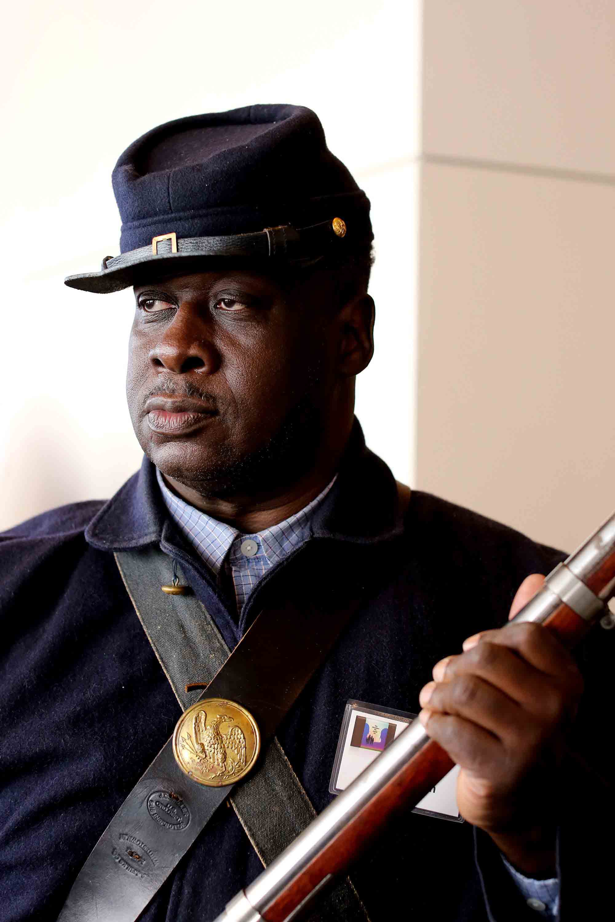 Sammy Aiken, a member of the 37th U.S. Colored Infantry Civil War Reenactors, stands by an exhibit at the N.C. Museum of History on Jan. 28, 2017.