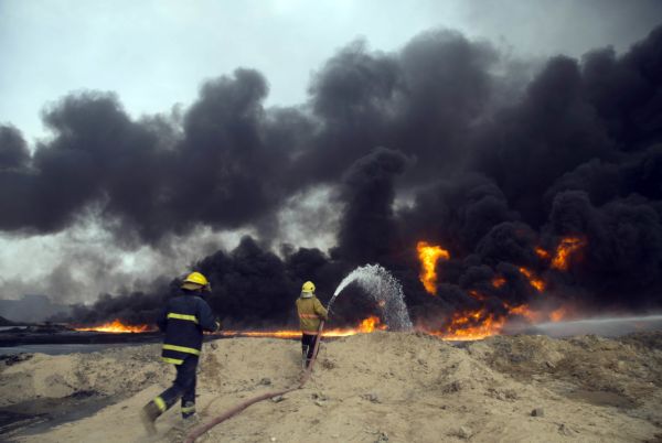 Iraqi firefighters battle a large fire at oil wells in Qayara, Iraq, on Aug. 31, 2016. (AP)