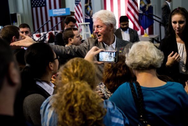 Former President Bill Clinton reaches out to shake hands after speaking to nearly 500 people on Oct. 3, 2016, at Northbank Center in Flint, Mich. (Jake May/Flint Journal via AP)