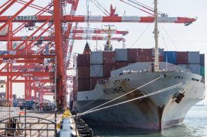 A container ship awaits being unloaded in a cargo terminal at a port in Tokyo in November 2013.