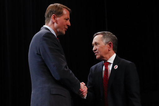 Richard Cordray, former federal consumer protection chief, left, and former U.S. Rep. Dennis Kucinich, right, shake hands after the Ohio Democratic Party debate in the primary race for governor, April 10, 2018, at Miami (Ohio) University. (AP)