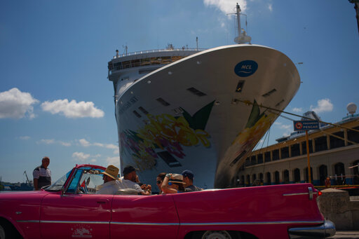 Tourists who have just disembarked from a cruise liner, tour the city aboard a vintage American convertible, in Havana, Cuba, Tuesday, June 4, 2019. The Trump administration has imposed major new travel restrictions on visits to Cuba by U.S. citizens. (AP