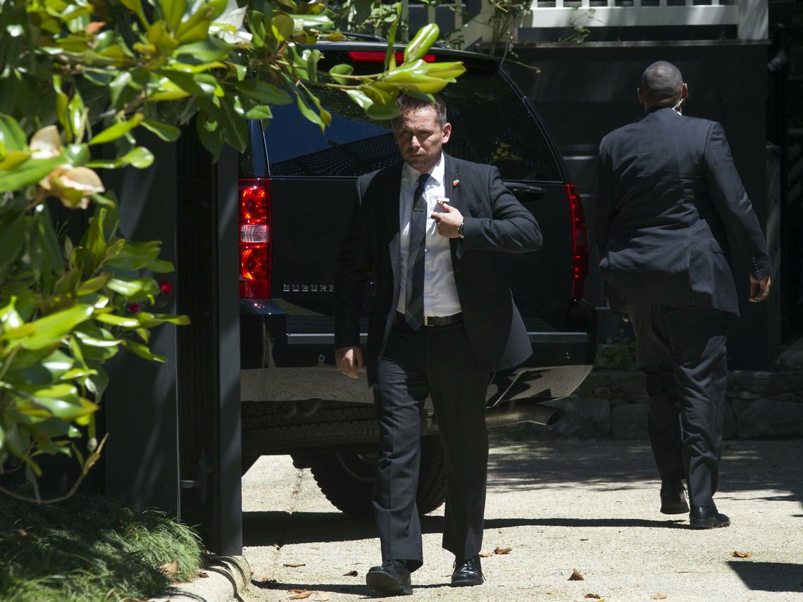 Agents stand guard around a Secret Service vehicle July 2, 2016, after it arrived at the home of Democratic presidential candidate Hillary Clinton in Washington. (Cliff Owen / Associated Press)