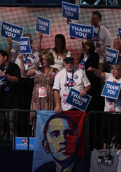 Delegates hold up "Thank You" signs during day three of DNC in Charlotte on Thursday. President Obama's nomination acceptance speech was aimed at convincing voters that a slow economic recovery will accelerate if they give him a second term.