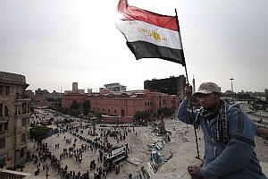 An anti-government protester waves an Egyptian flag in Cairo on Friday