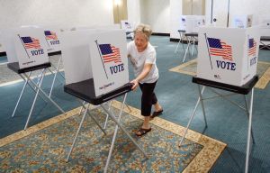 A Florida poll worker arranges voting booths. (2010 Tampa Bay Times photo)