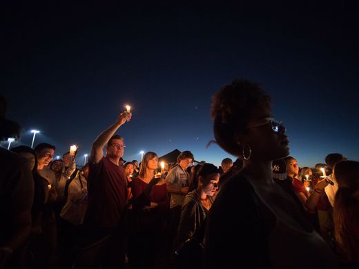 A candlelight vigil was held the day after the mass shooting at a Florida high school. (USA Today Network)