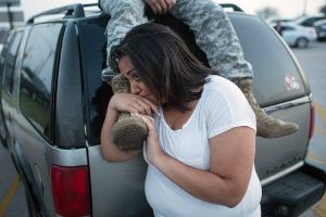 Lucy Hamlin and her husband, Spc. Timothy Hamlin, wait for permission to re-enter the Fort Hood military base, where they live, following a shooting on the base. (AP)