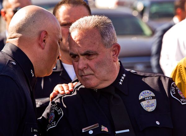 Steve Zipperman, chief of the Los Angeles Unified School District police force, right, is briefed outside the Belmont High School complex on Feb. 1, 2018, after two students were shot and wounded, one critically, inside a Los Angeles middle school.