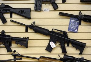 Guns, including an AR-15 semi-automatic rifle, for sale at a shop in Pasadena, Maryland, Jan. 14, 2013.