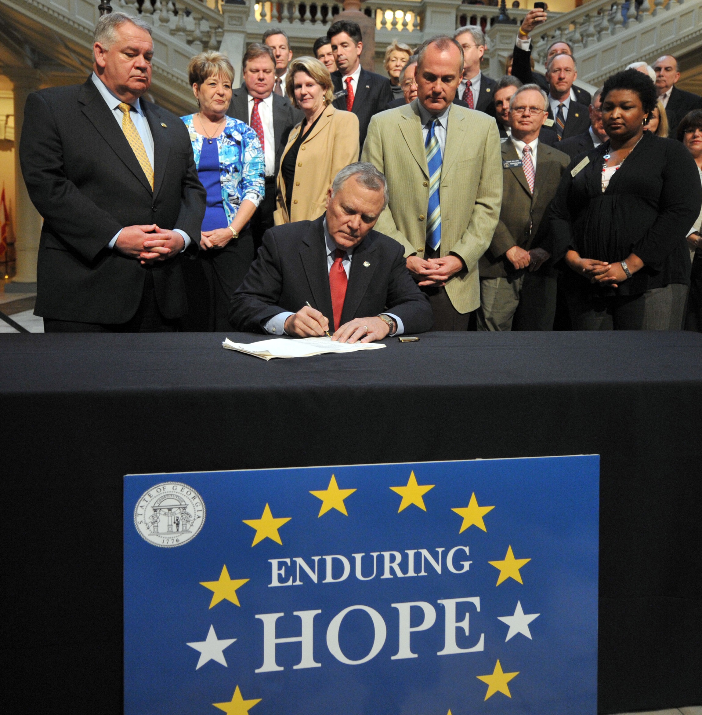 Gov. Nathan Deal signs the bill overhauling the cash-strapped HOPE Scholarship in 2011. Photo by Brant Sanderlin / AJC